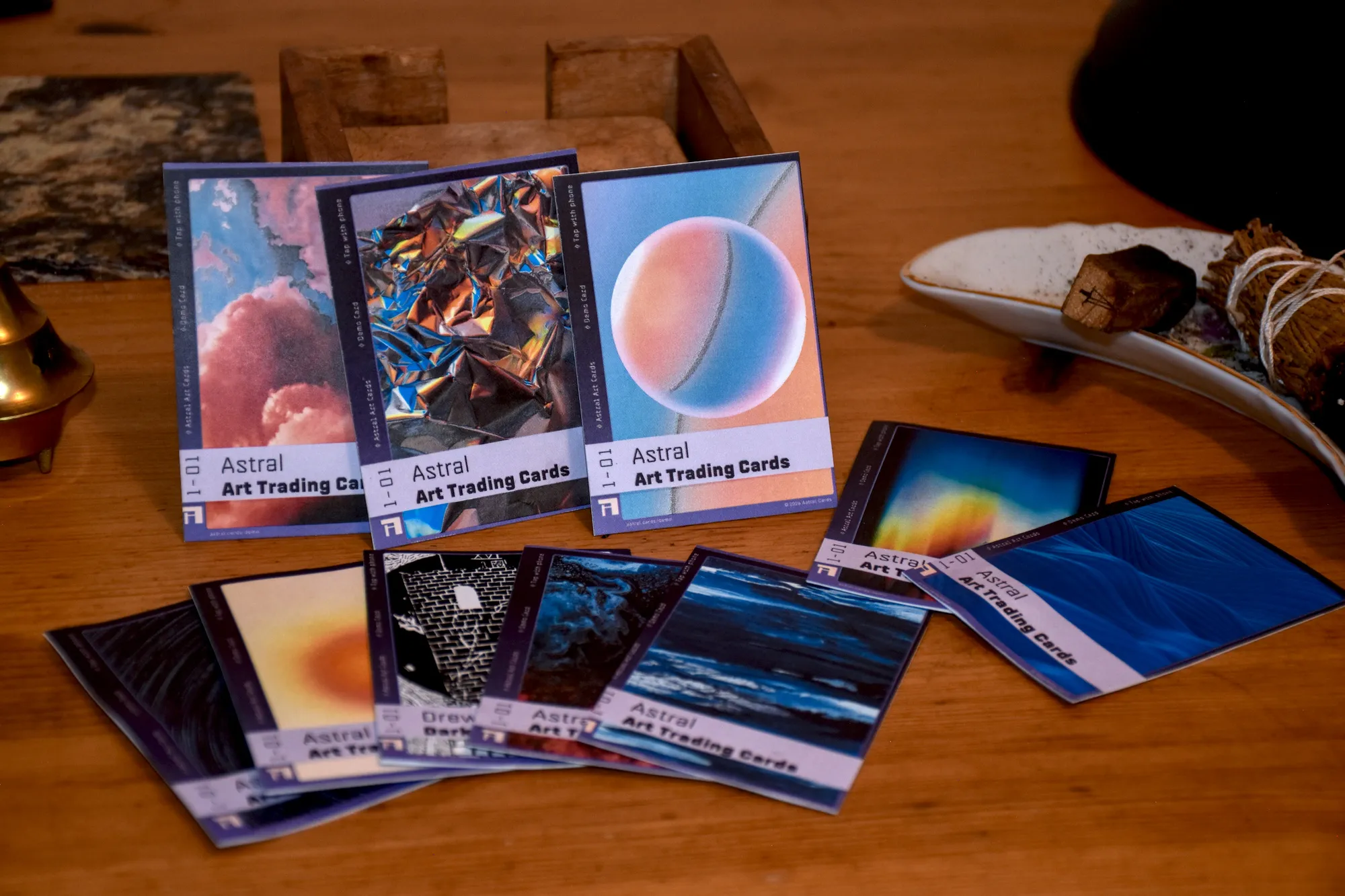 Astral cards laid out on a table next to a phone.